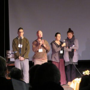 A group of people talking on a stage
